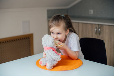 Portrait of cute girl sitting at home