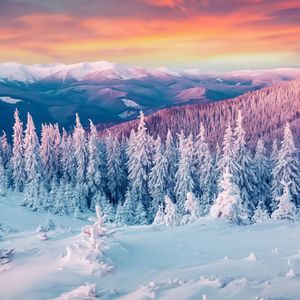 Scenic view of snowcapped mountains during sunset