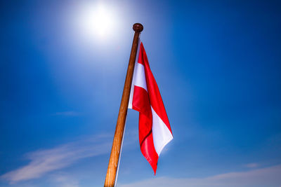 Low angle view of flag against blue sky