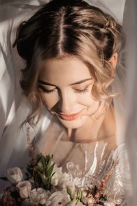 Close-up of young woman with flowers