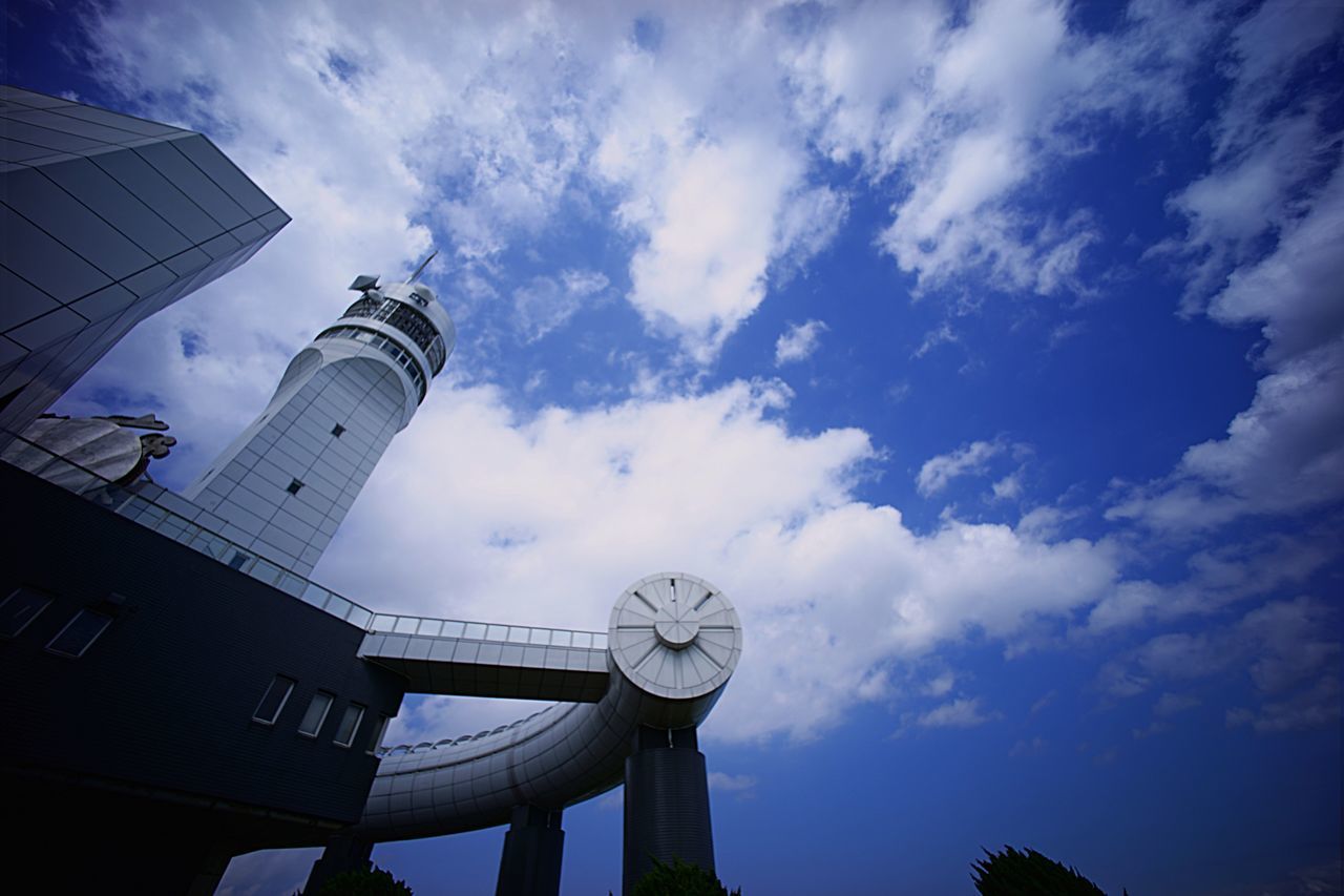 low angle view, sky, architecture, built structure, cloud - sky, building exterior, tower, tall - high, cloud, cloudy, blue, outdoors, day, communication, no people, communications tower, silhouette, smoke stack, travel destinations, tall