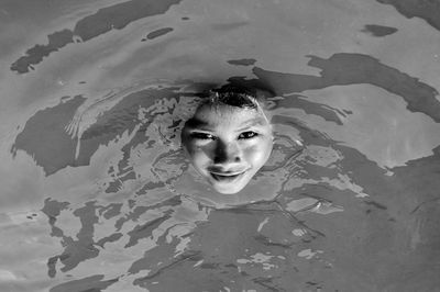 High angle portrait of boy swimming in water
