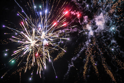 Low angle view of firework display at night