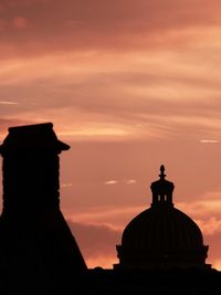 Silhouette built structure against sky at sunset