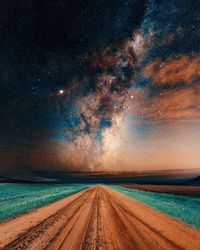 Scenic view of road against sky at night