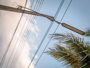 Low angle view of electricity pylon against sky