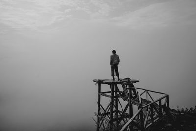 Rear view of man standing against sky