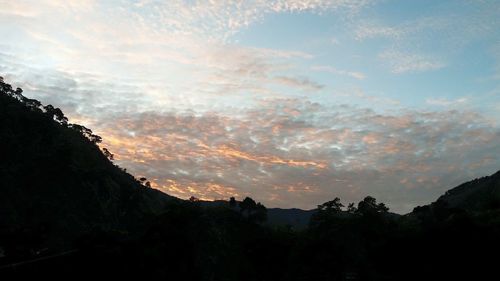 Scenic view of silhouette mountains against sky at sunset