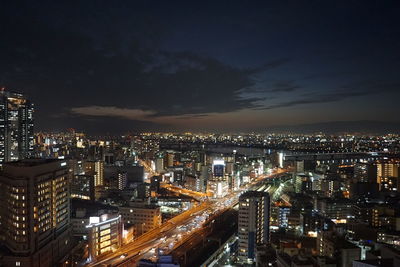 High angle view of illuminated city buildings at night