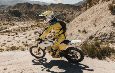 Man riding bicycle on desert