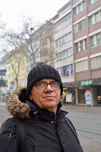 Portrait of mature man in city during winter