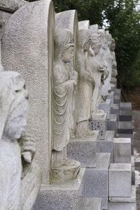 Statues on stone wall