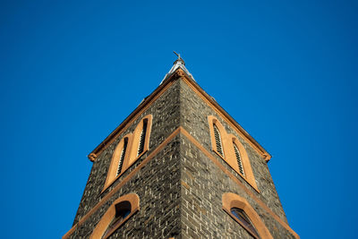 Low angle view of building against clear blue sky