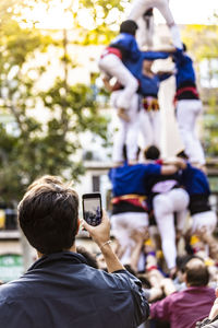 Rear view of people photographing