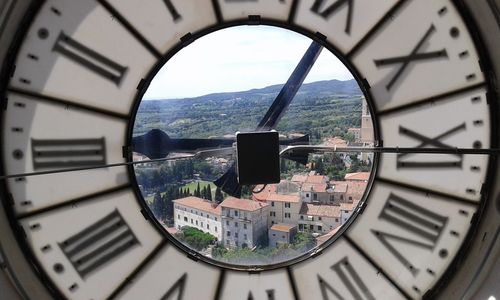 Buildings in town seen through clock