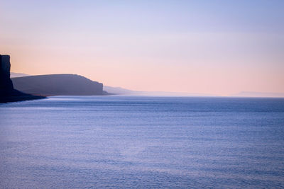 Scenic view of sea against clear sky during sunset