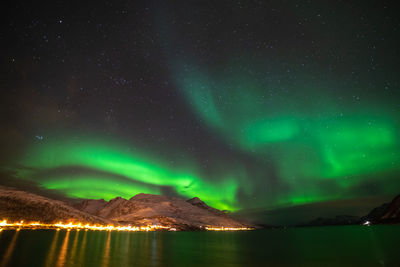 Scenic view of lake against sky at night