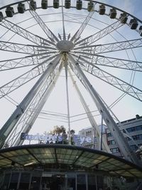 Low angle view of ferris wheel against sky