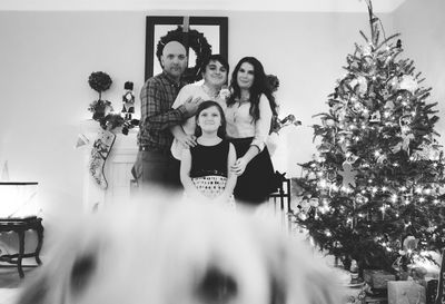 Blurred motion of cropped dog head against family portrait
