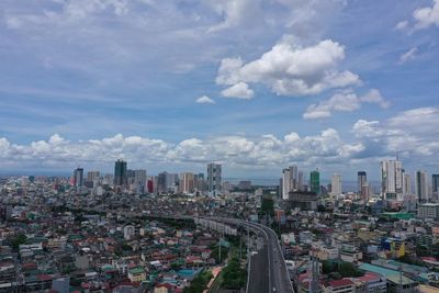 High angle view of modern buildings in city against sky