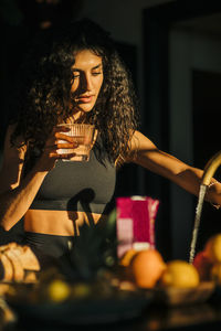 Woman holding glass of water at retreat center