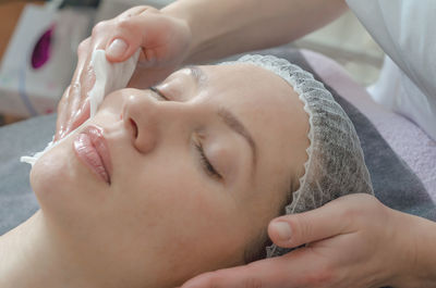 Close-up woman face in beauty spa on couch. relaxation, rejuvenation.