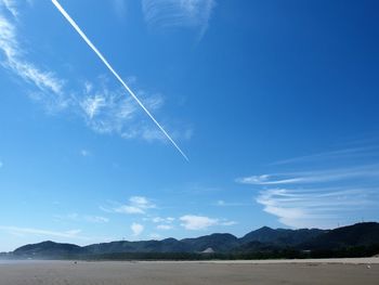 Scenic view of vapor trail against blue sky