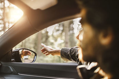 Reflection of man in car mirror
