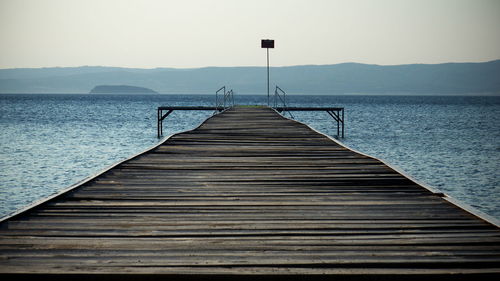 Pier over sea against sky