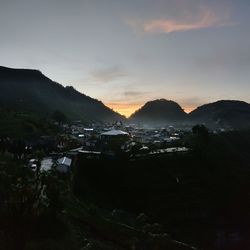 Scenic view of silhouette mountains against sky at sunset