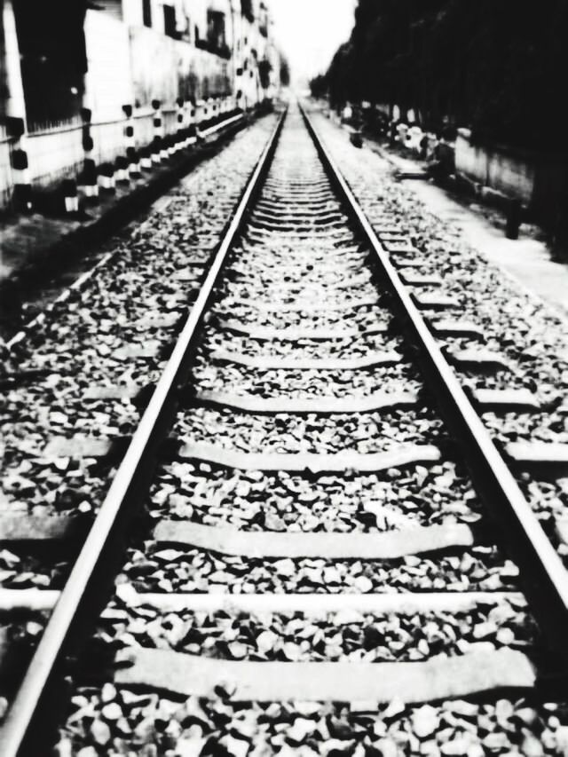 diminishing perspective, railroad track, transportation, the way forward, vanishing point, rail transportation, text, high angle view, railroad station platform, incidental people, day, railroad station, communication, western script, in a row, metal, connection, public transportation, outdoors, no people