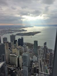 High angle view of cityscape against cloudy sky