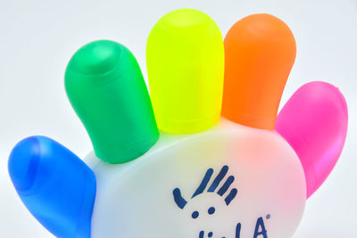 Close-up of multi colored balloons against white background