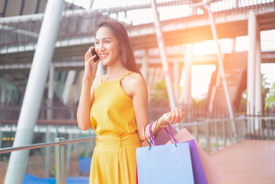 Young woman using mobile phone outdoors