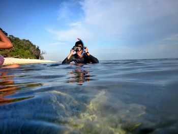 Young woman swimming in sea