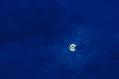 Low angle view of moon against blue sky