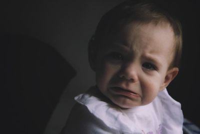 Close-up portrait of cute baby girl crying