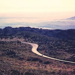 High angle view of winding road on landscape against sky