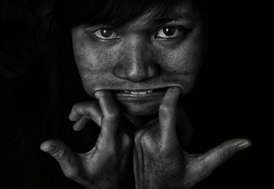 Close-up portrait of young woman making a face