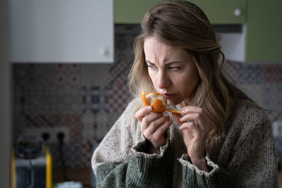 Close-up of woman holding orange