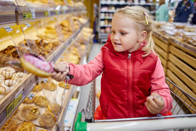 Cute girl looking away at store