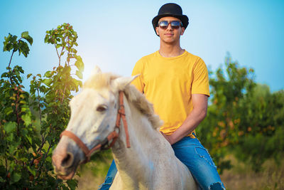 Portrait of young woman riding horse