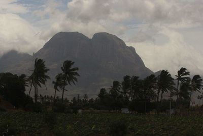 Scenic view of mountains against cloudy sky