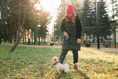 Rear view of woman standing in park