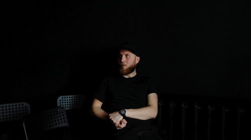 Young man in darkroom