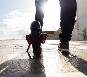 Low section of man walking on street