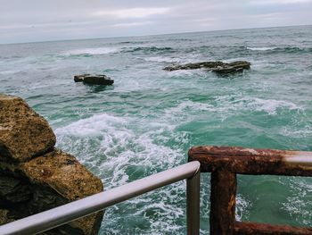 Scenic view of rocks in sea against sky