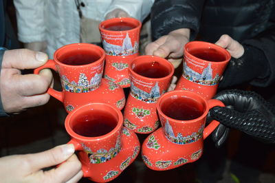 Cropped hands toasting drink cups