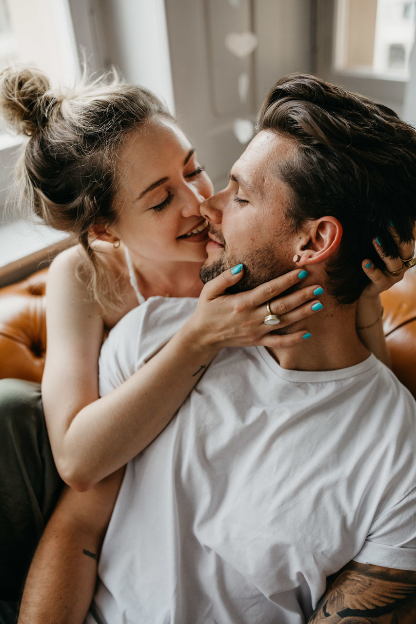 Loving young couple romancing at home