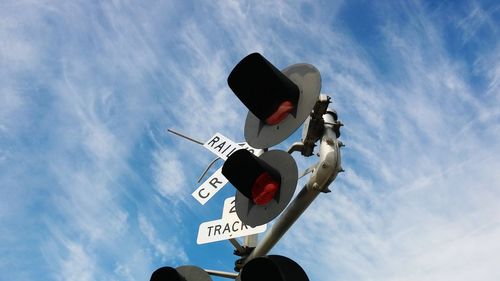 Low angle view of road sign against sky